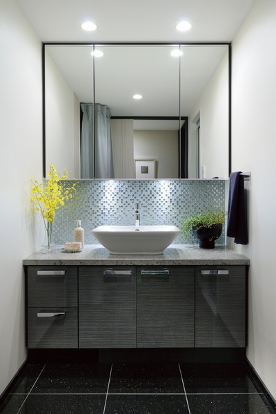 Wash basin with a three-sided mirror back storage. Beautiful mosaic tile under the mirror