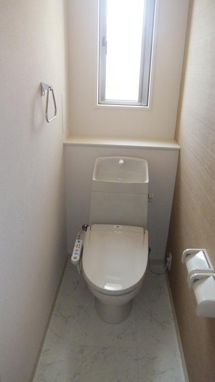 Toilet. It is bright because there is a window