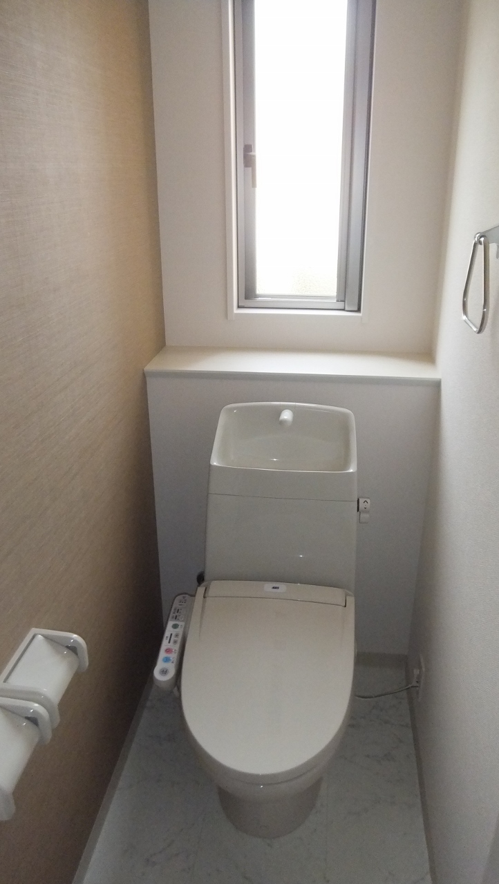 Toilet. It is bright because there is a window