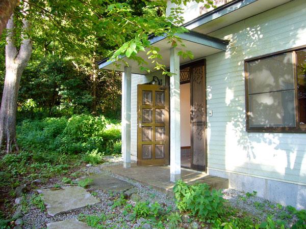 Local appearance photo. To the front door with a green approach