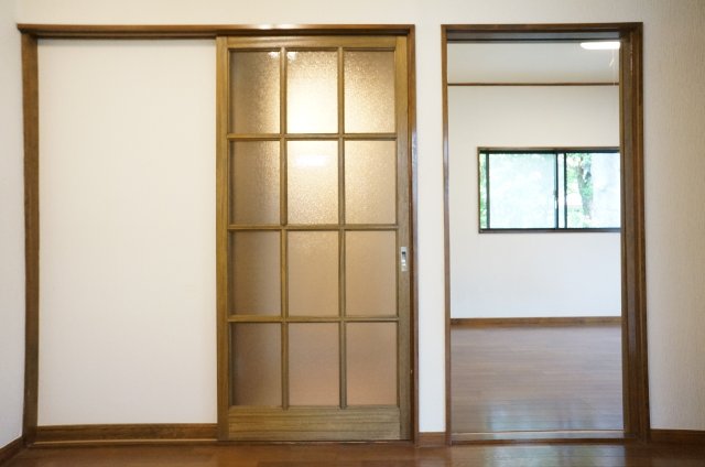 Other room space. It is a glass door that separates the dressing room and the kitchen