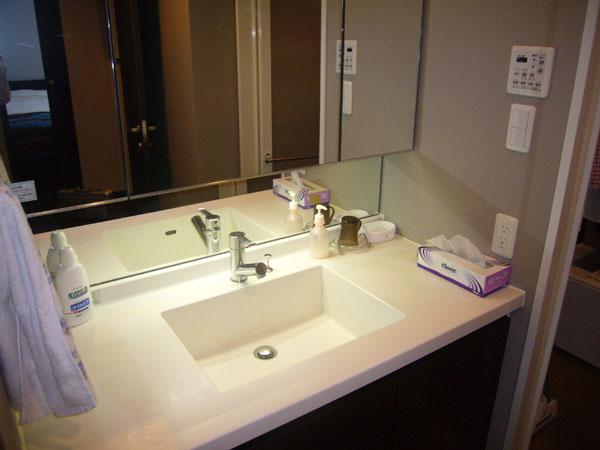 Wash basin, toilet. Is a wash room. It is like a beautiful resort hotel.