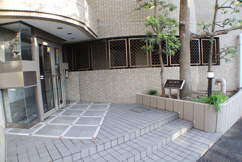 Entrance. Local (12 May 2013) shooting quietly in front of the entrance, Symbol tree greets.