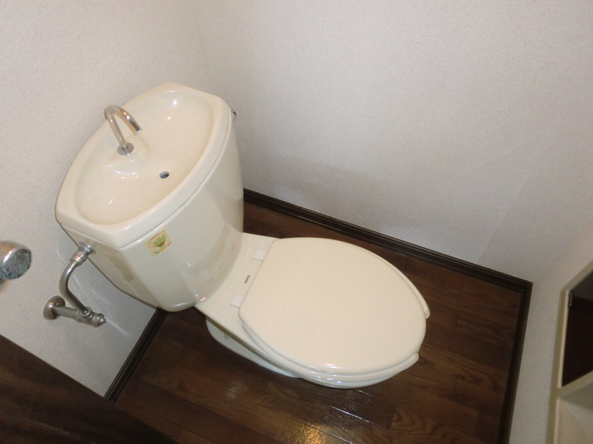 Toilet. It comes with a storage rack