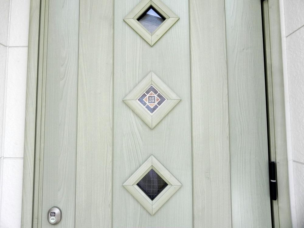 Local appearance photo. Lovely entrance door is stained glass in pale green door