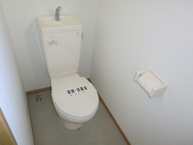 Toilet. It is bright because there is a window in the toilet