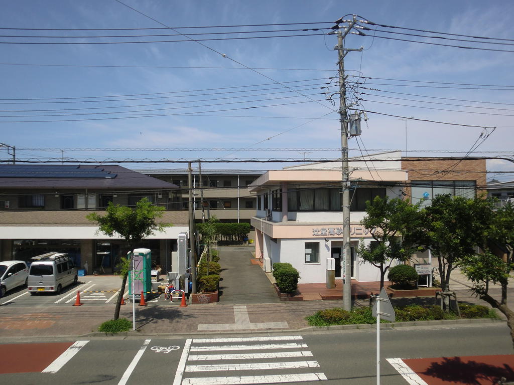 View. Town tree-lined green is visible. It is a convenience store in front of
