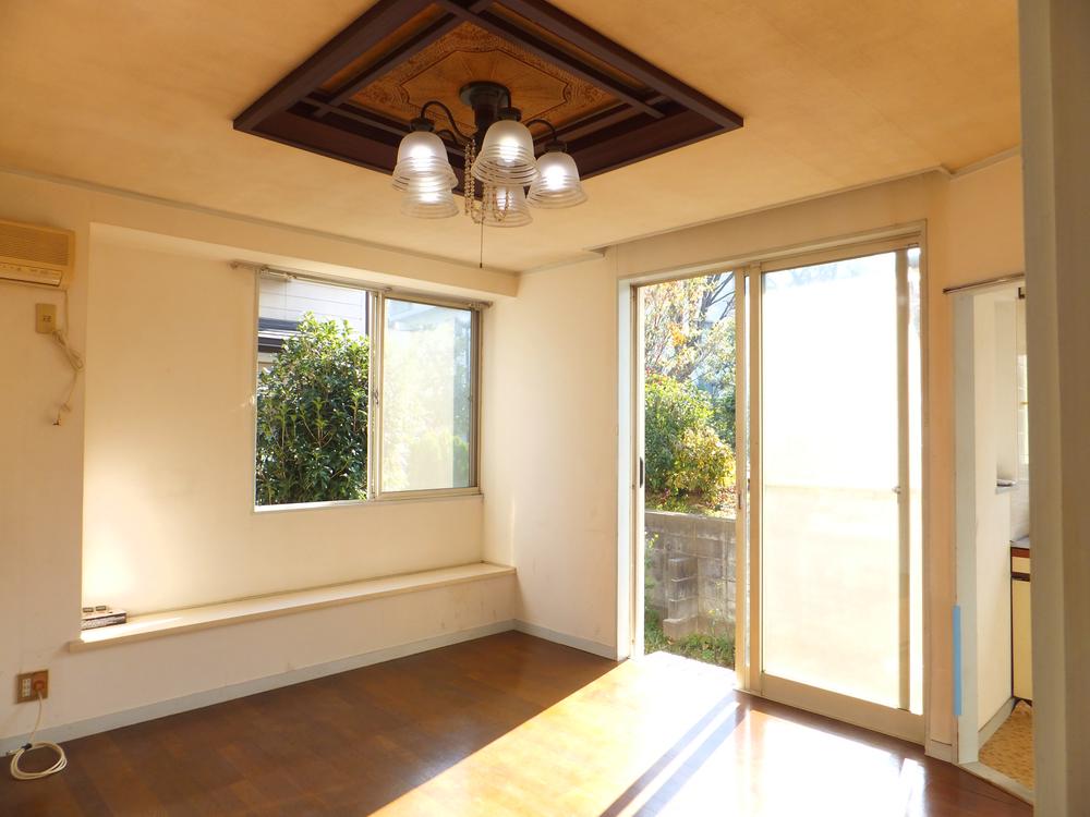 Living. Also bathed in sunlight from the living room bay window. Family smile at the lighting boast of living