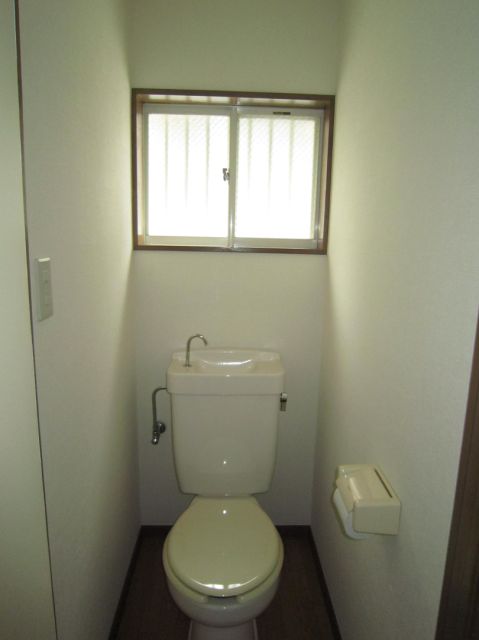 Toilet. It has a window in the restroom