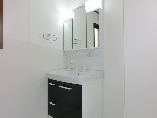 Wash basin, toilet. It is the washroom.
