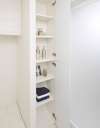 Bathing-wash room.  [Linen cabinet] Convenient linen shelves for storage of towels and laundry supplies. It maintains the integrity of the organized space.