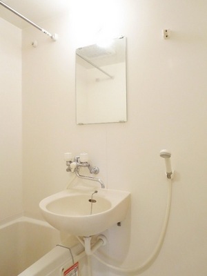 Washroom. Wash basin with a mirror. Sharing a room with bathroom. 