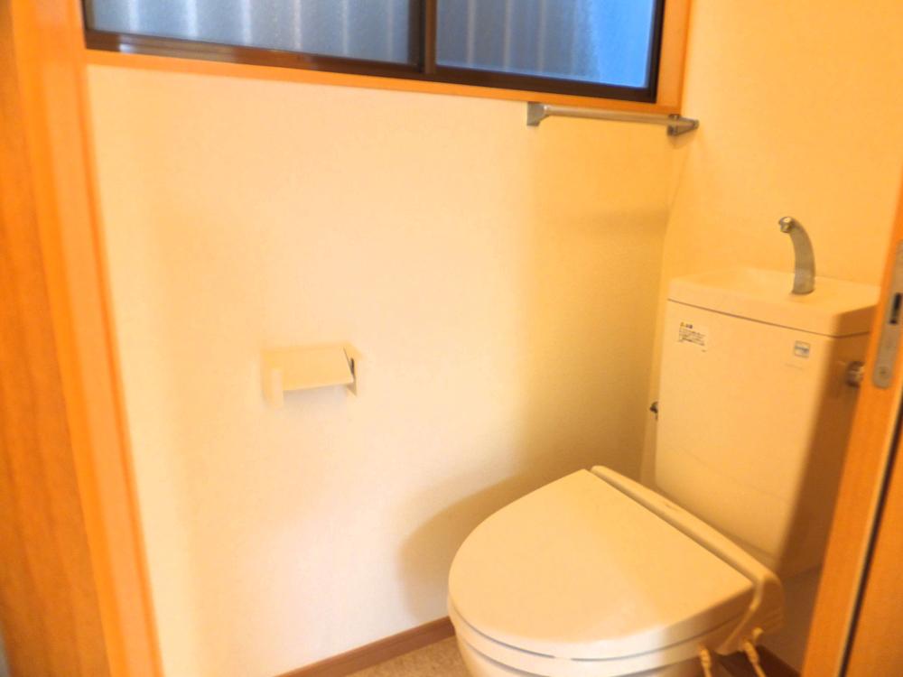 Toilet. It is a window with bright toilet.