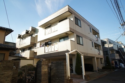 Building appearance. White tiles shine in blue sky