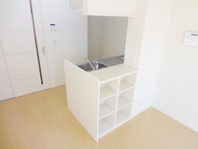 Other room space. It is a useful counter kitchen with shelf