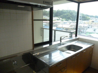 Kitchen. There are large windows, Bright kitchen