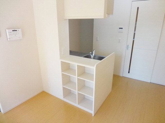 Other room space. It is a useful counter kitchen with shelf