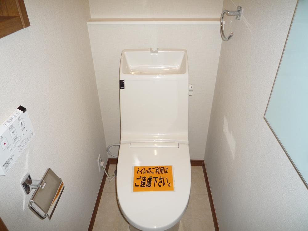 Toilet. Toilet is equipped with hot-water cleaning function. (Photo 9 Building)