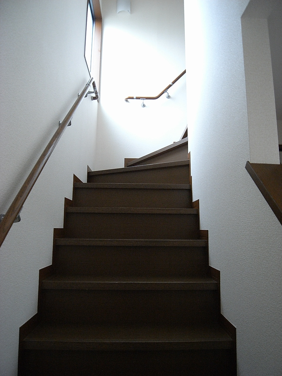 Other. Handrail is attached to the stairs.