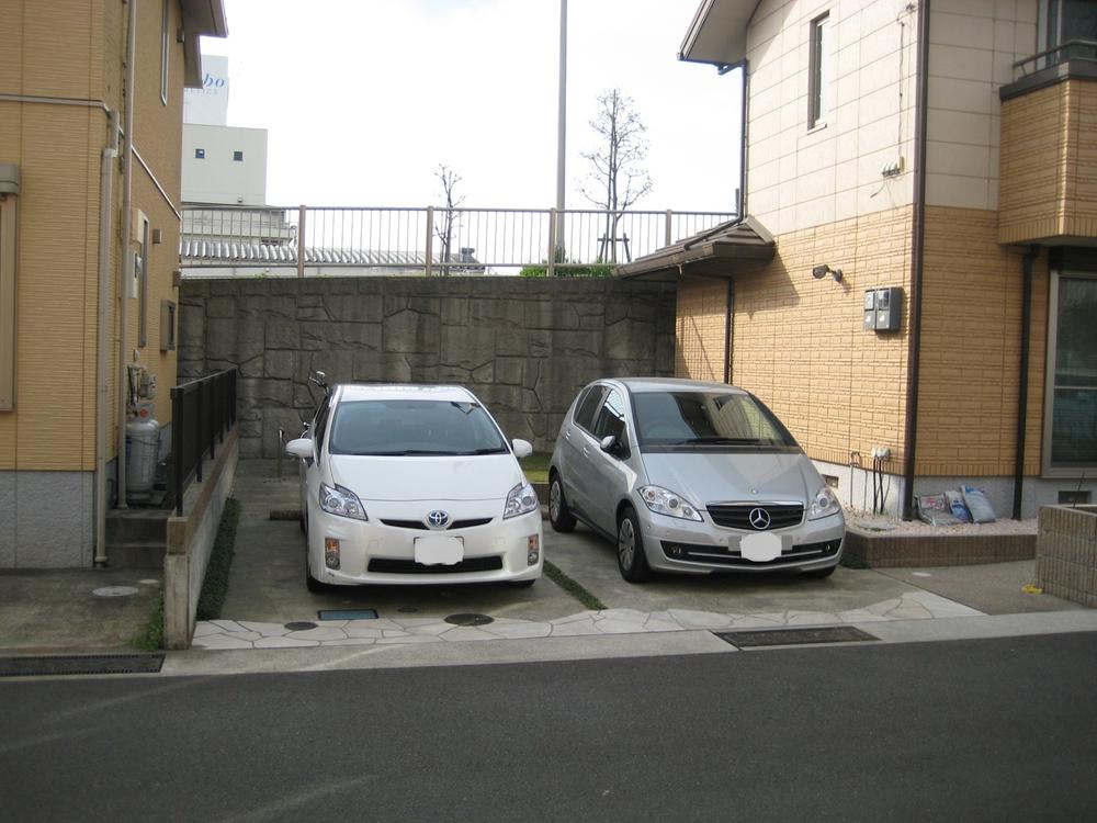 Parking lot. There are two cars car space. (Local photo)