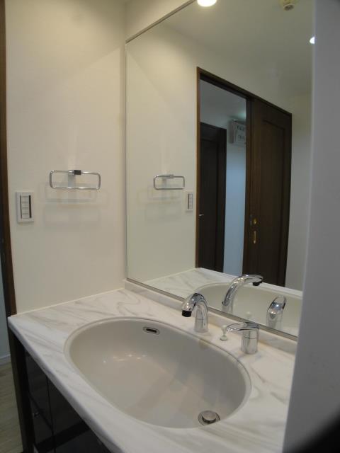 Wash basin, toilet. Basin has renovation taking advantage of the intact classy.