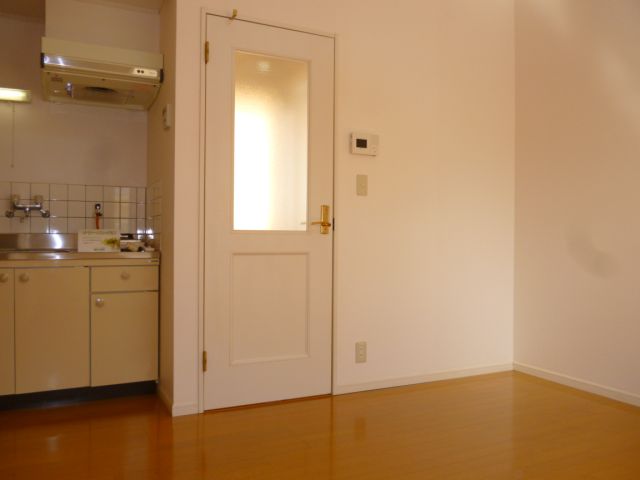 Living and room. There is a door between the entrance of the room.