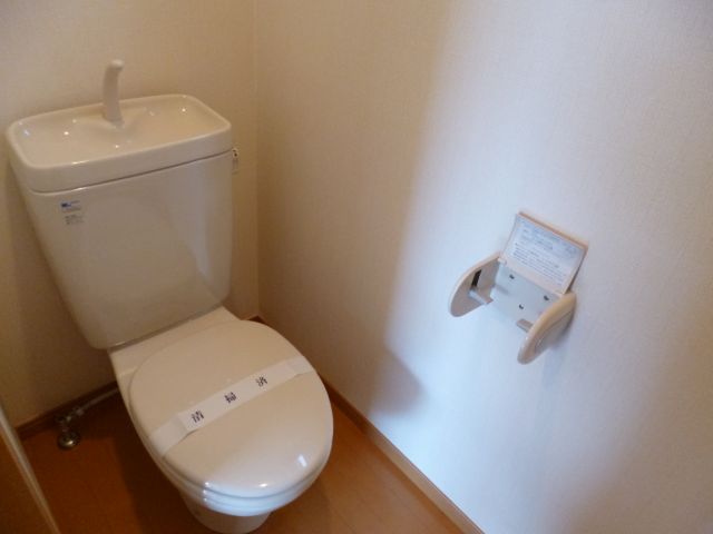 Toilet. There is a window in the toilet is a bright room.