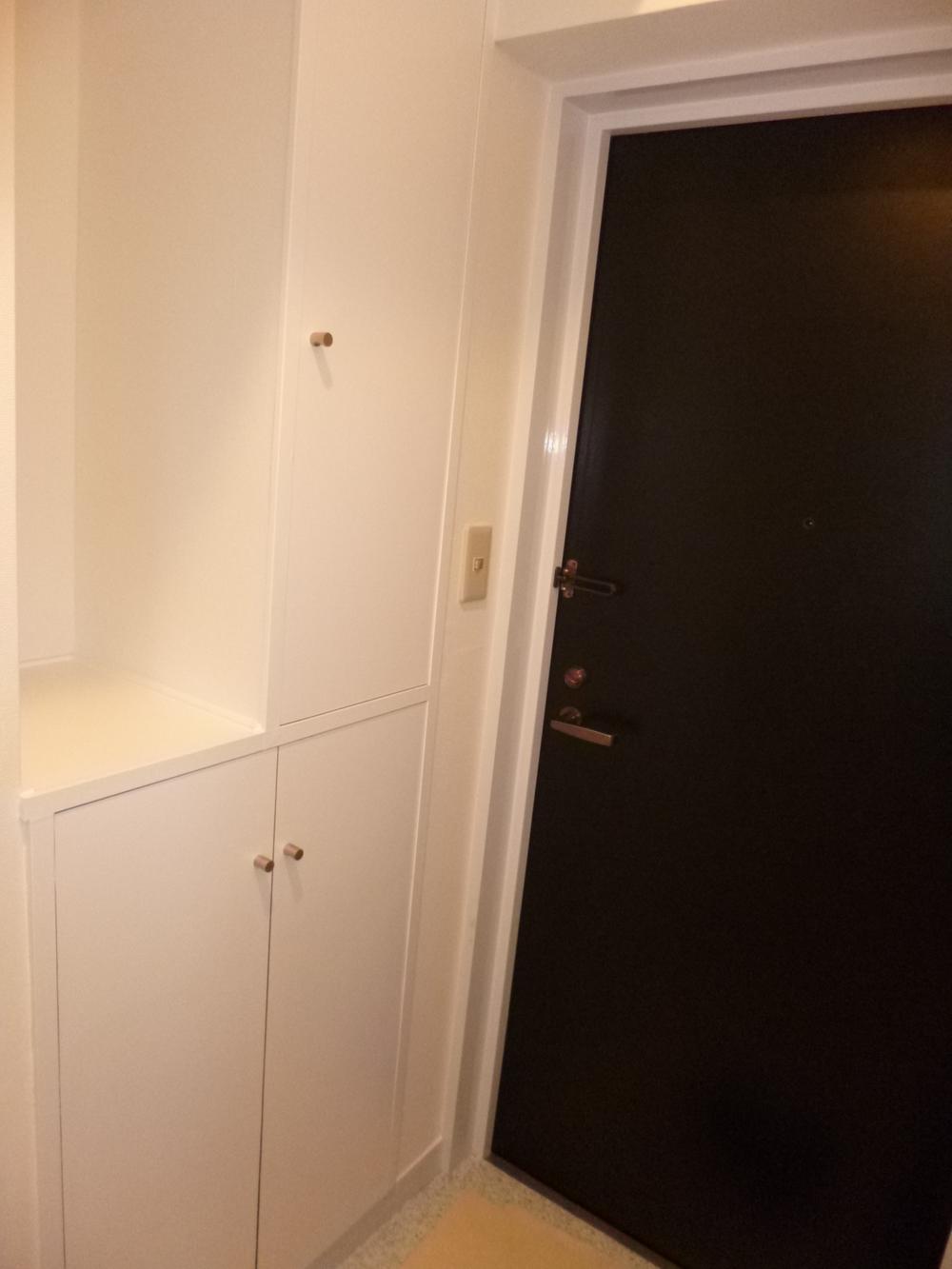 Entrance. Shoes cloak now also is the front door painted in white are feeling bright.