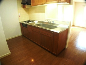 Kitchen. It is counter kitchen of stylish woodgrain.