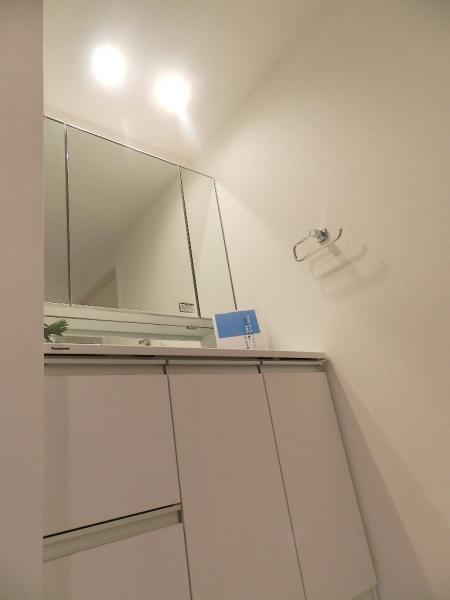 Wash basin, toilet. Bright vanity of the three-sided mirror with