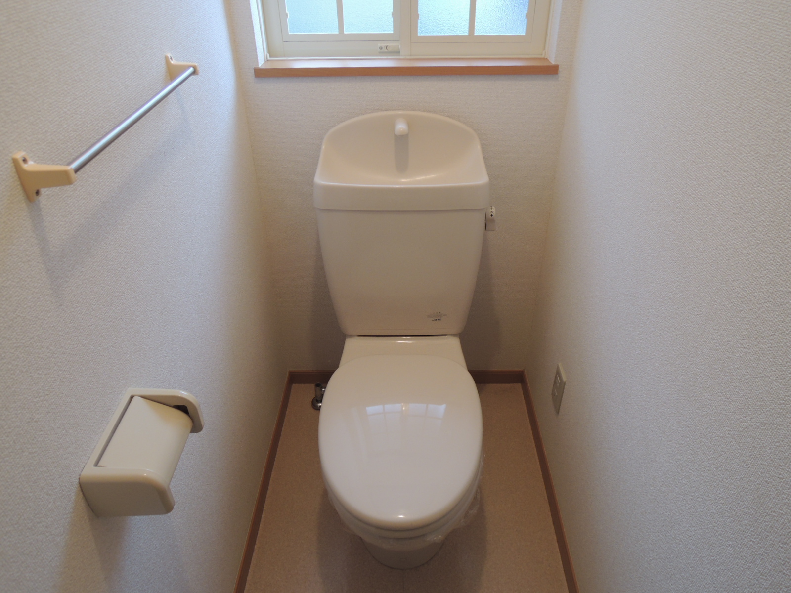 Toilet. There is a window in the toilet