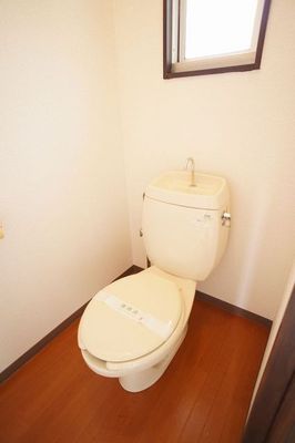Toilet. There is a small window