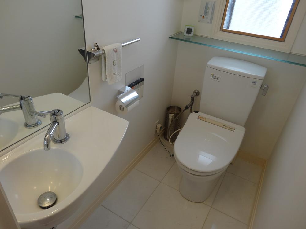 Toilet. With hand washing faucet in the toilet. You can natural ventilation because there is a window.