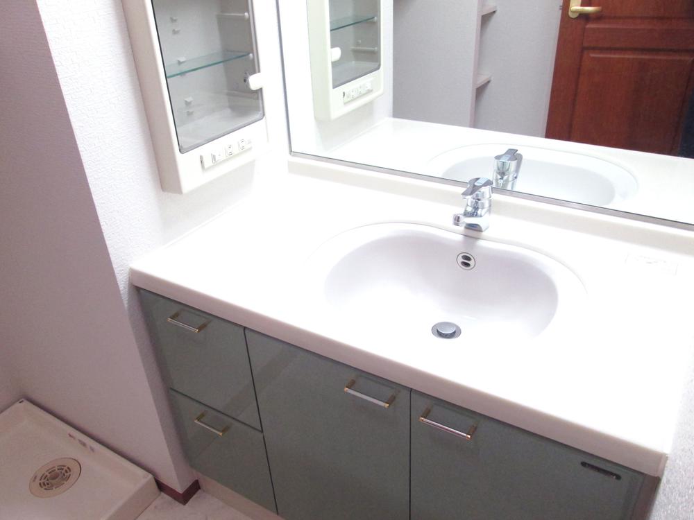 Wash basin, toilet. Washroom is a little spread