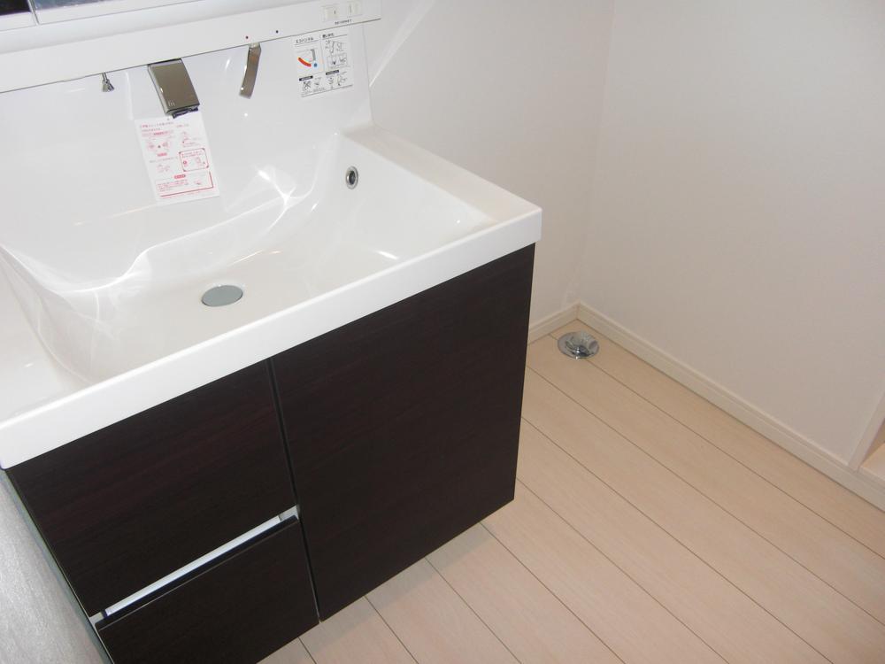 Wash basin, toilet. Laundry Area also put a drum type