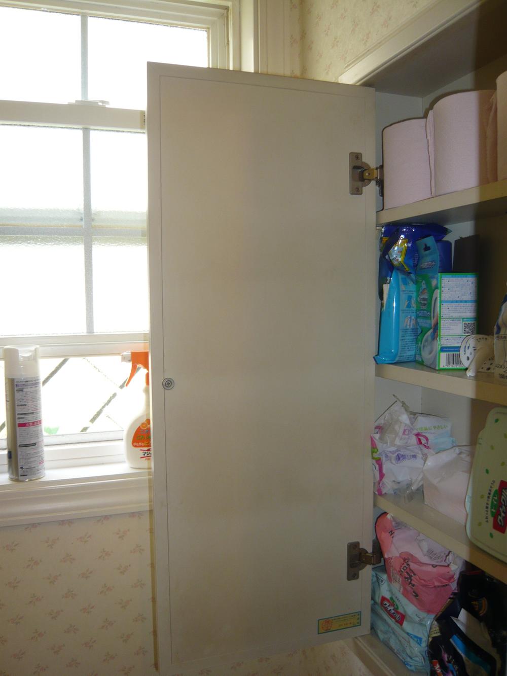 Toilet. With windows for ventilation and accessories housed in toilet