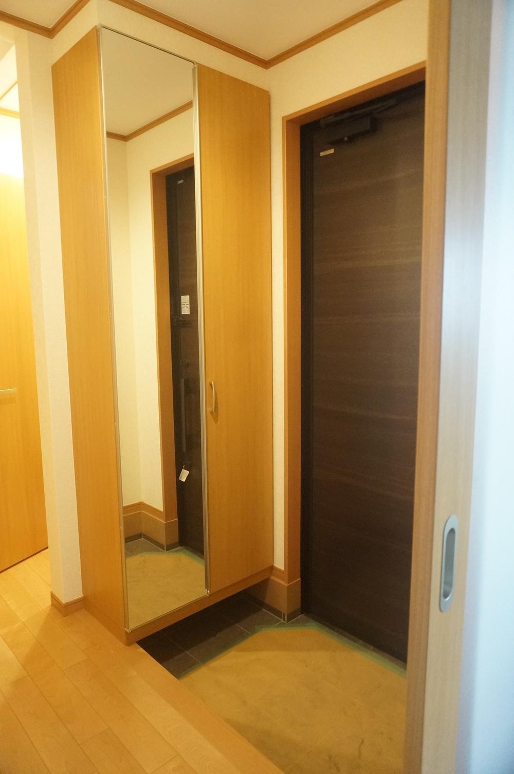 Entrance. A Building Cupboard with a mirror