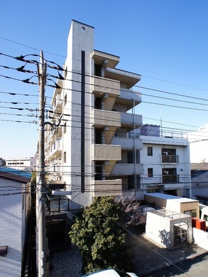 Building appearance. Tiled apartment shine in blue sky