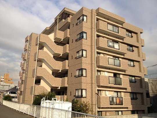 Local appearance photo. Building appearance.  It is tiled Riverside apartment bright beige!