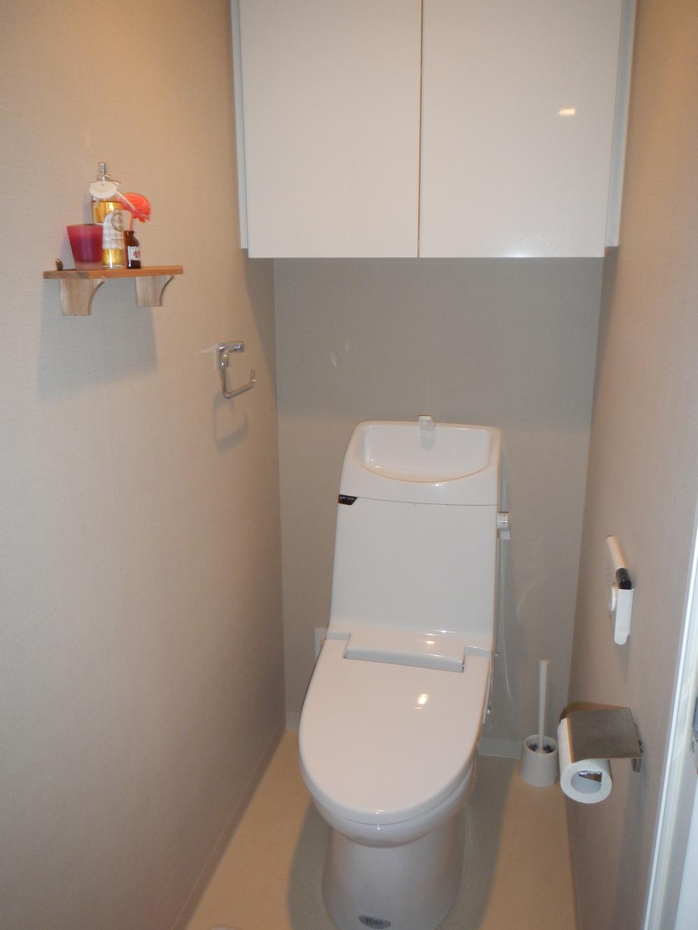 Toilet. With hanging cupboard