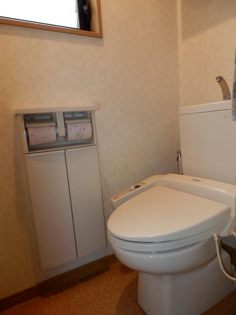 Toilet. Large windows in restroom, We also attached, such as a wall with paper holder. 