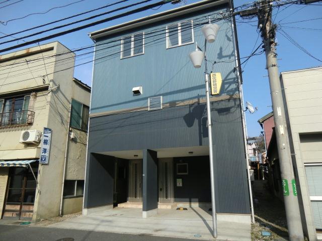 Local appearance photo. Facing the main street is a three-story house