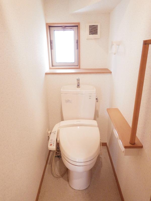 Toilet. Toilet of peace of mind with a handrail