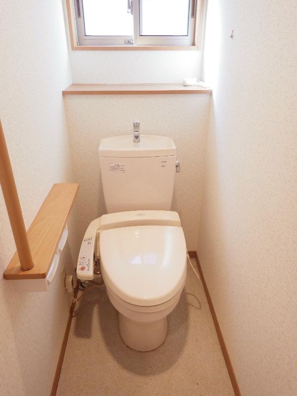 Toilet. There are also railing on the second floor of the toilet