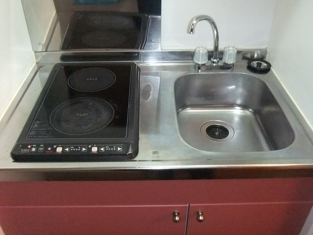 Kitchen. 2 is a neck kitchen with electric stove is attached of.