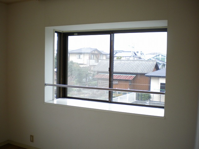 Living and room. Bay window overlooking a view of the outside calmly