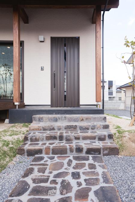 Entrance. Approach of the entrance. Entrance made of stone pavement. At night illuminated with light, Out the atmosphere.