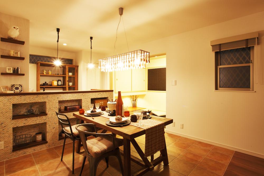 Model house photo. The stylish atmosphere in the cabinet of unique lighting and kitchen fork and spoon on dining. 