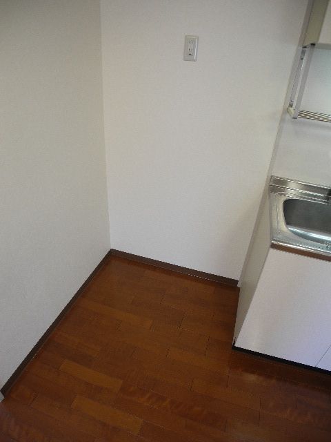 Other room space. A refrigerator is put next to the kitchen