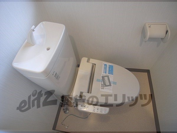 Toilet. It is with washing machine.